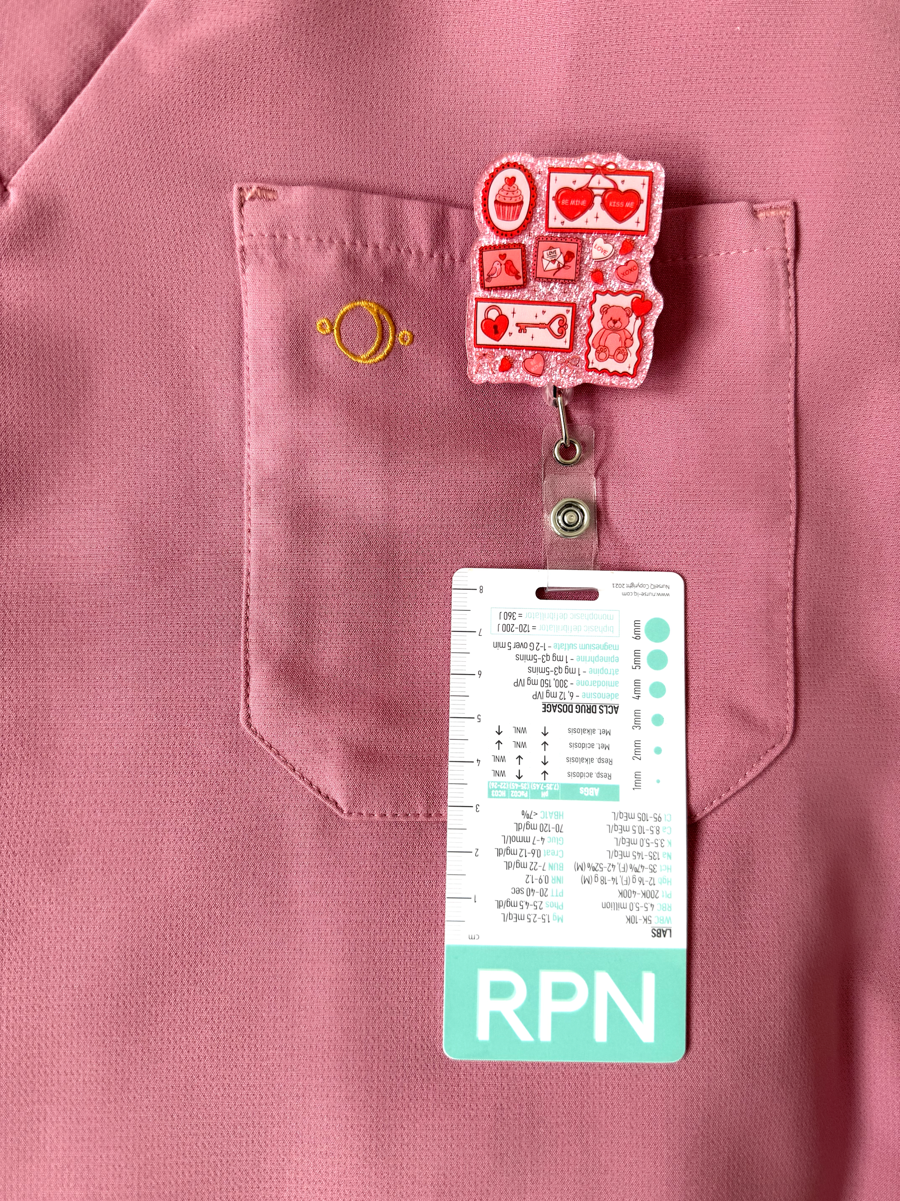 Pink shirt with a pocket and an 'RPN' badge holder attached
